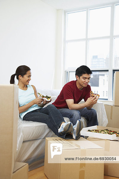 Couple Eating Pizza in New Condo