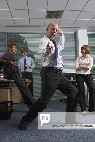 Manager Dancing for Staff in Office