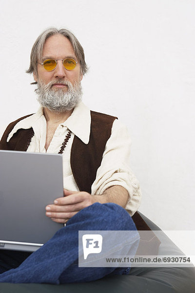 Portrait of Man Holding Laptop Computer