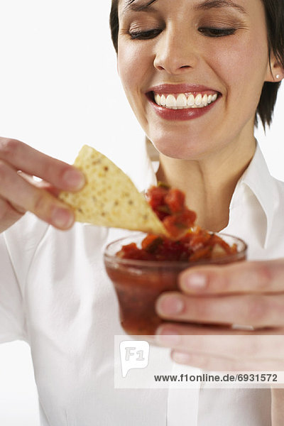 Woman Eating Salsa and Nachos