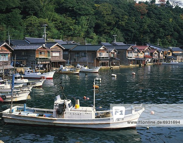 Houses and boats on a river in Kyoto  Japan