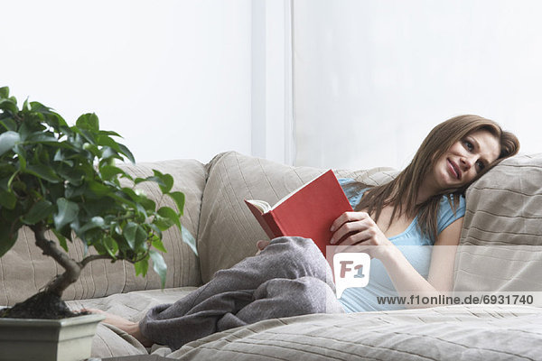 Woman on Sofa  Reading Book