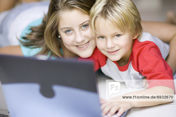 Girl and Boy Using Laptop Computer