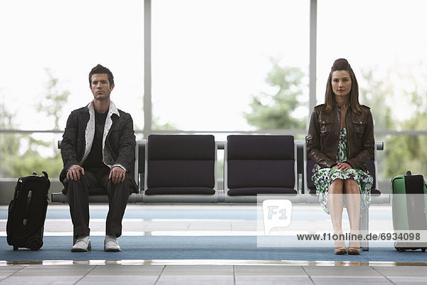 Man and Woman in Airport Waiting Area