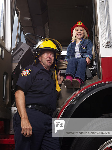 Girl and Firefighter in Fire Truck