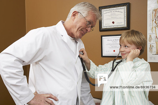 Boy Playing with Doctors Stethoscope