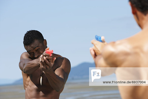 Men with Water Guns at Beach