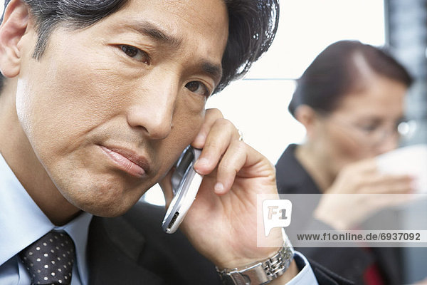 Close-up of Businessman Using Cell Phone