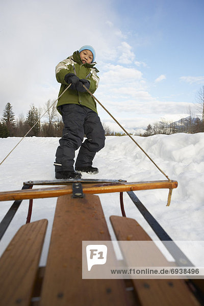 Boy Pulling Sled  Whistler  British Columbia  Canada