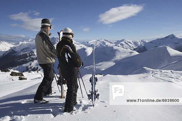 Two Men on Top of Ski Hill  Whislter  BC  Canada