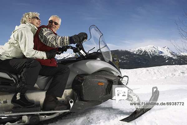 Couple Snowmobiling