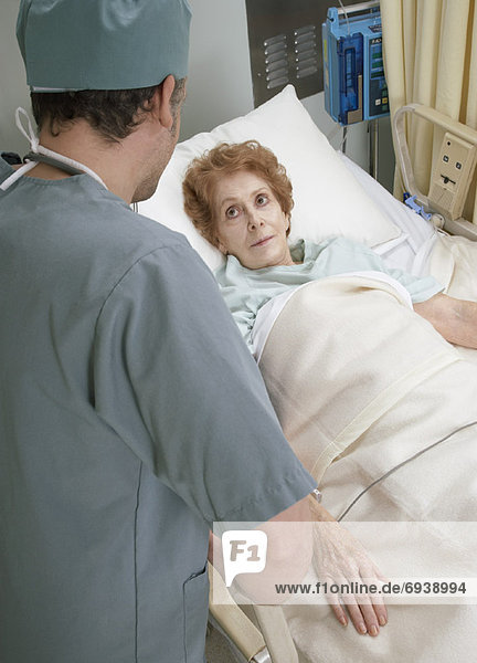 Doctor Talking to Patient in Hosptial Bed
