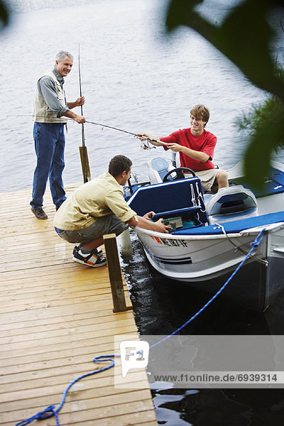Man and Teenagers Fishing  Belgrade Lakes  Maine  USA