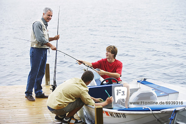 Man and Teenagers Fishing  Belgrade Lakes  Maine  USA