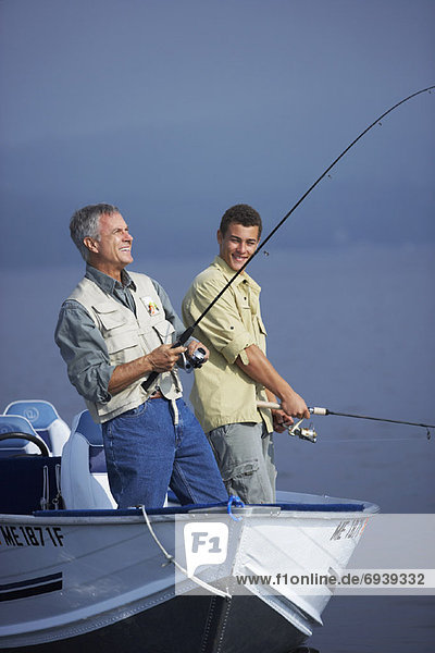 Man and Teenager Fishing  Belgrade Lakes  Maine  USA