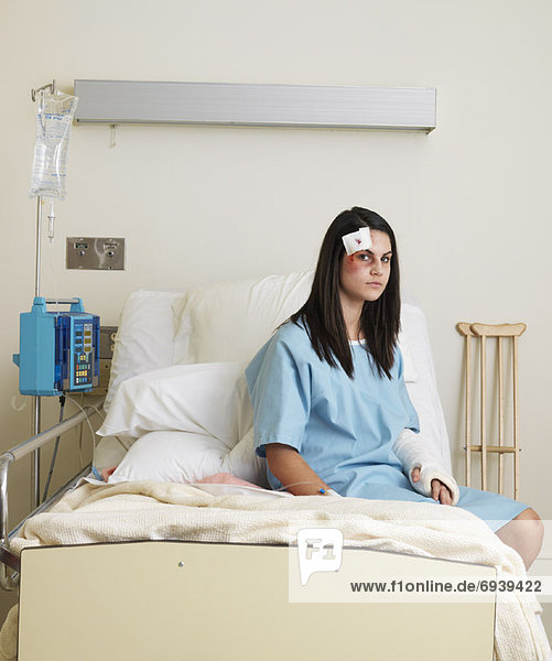 Woman in Hospital Room with Injuries