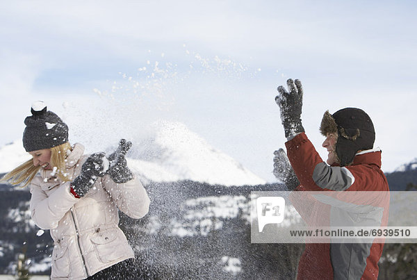 Couple Having Snowball Fight
