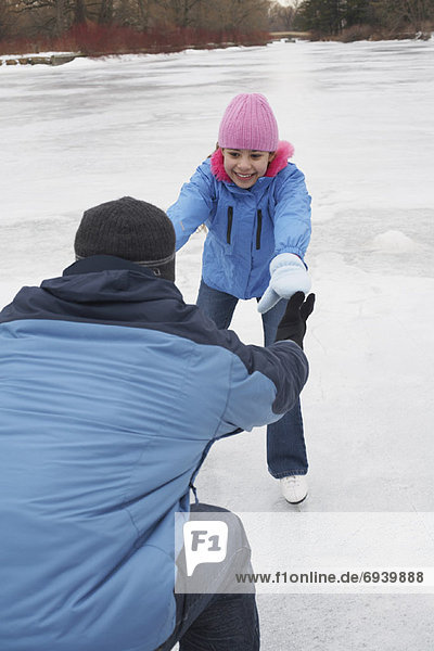 Father Teaching Daughter to Skate