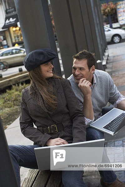 Portrait of Couple with Laptops