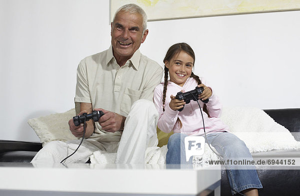 Grandfather and Granddaughter Playing Video Games