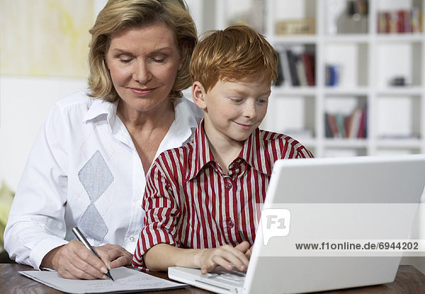 Grandmother and Grandson Using Laptop