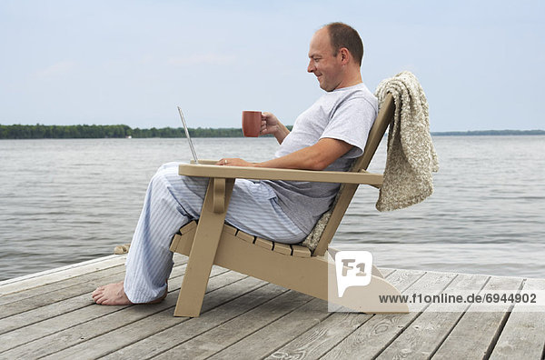 Man Relaxing on Dock
