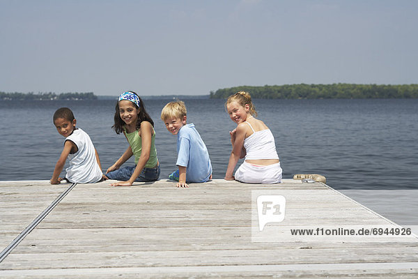 Children Sitting on Dock
