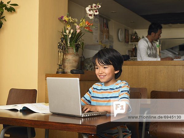 Boy with Homework in Restaurant