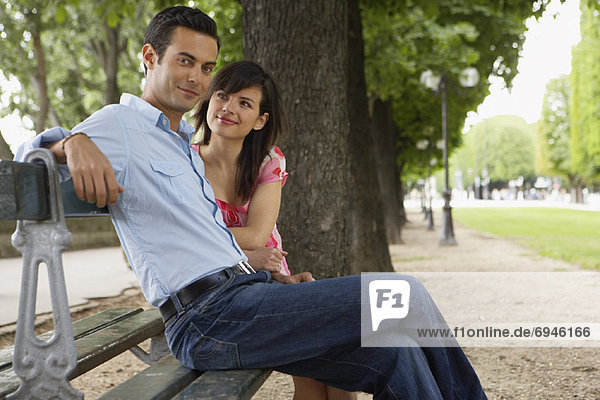 Couple Sitting on Park Bench