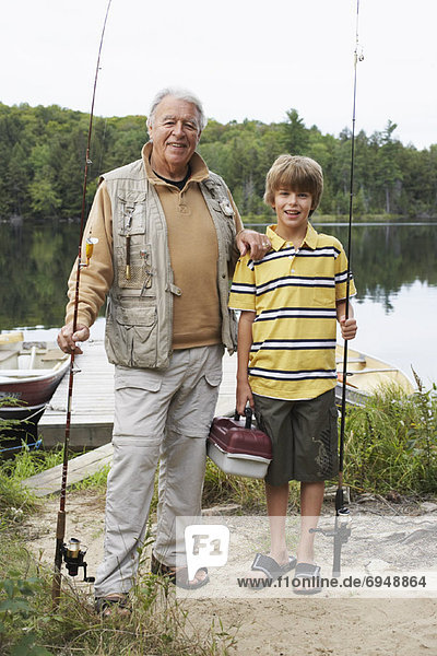 Man and Boy by Lake with Fishing Gear