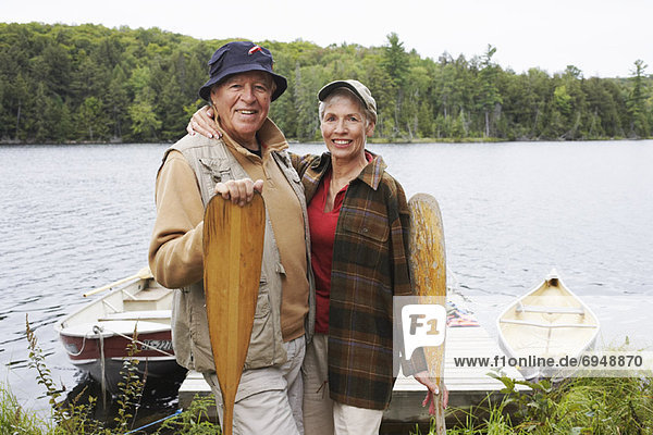 Couple by Dock with Canoe Paddles