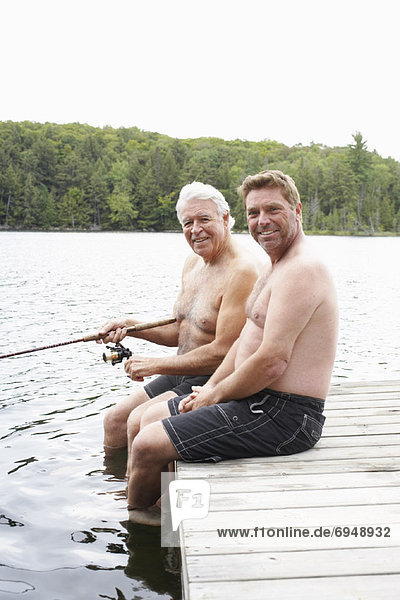 Father and Son Fishing on Dock