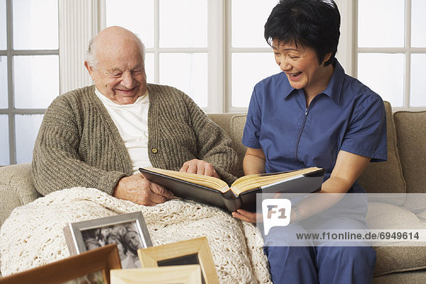 Senior Man with Woman Looking at Pictures Together