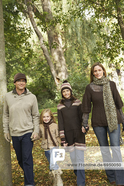 Portrait of Family Walking in Park  in Autumn