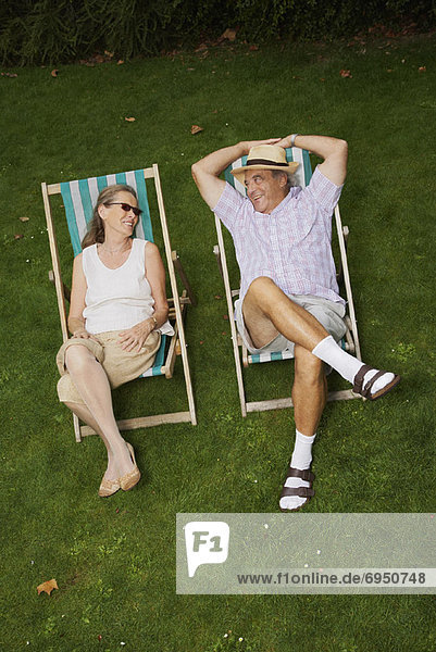 Couple Sitting in Lawn Chairs