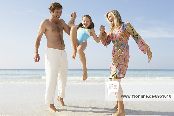 Parents Lifting up Daughter on Beach  Majorca  Spain