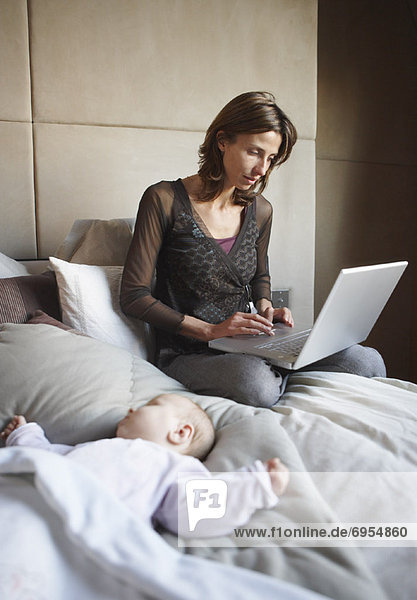 Woman with Baby and Laptop Computer