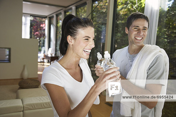 Couple Drinking Water after Exercising