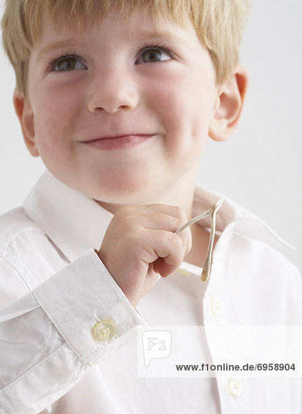 Portrait of Boy Holding Wishbone