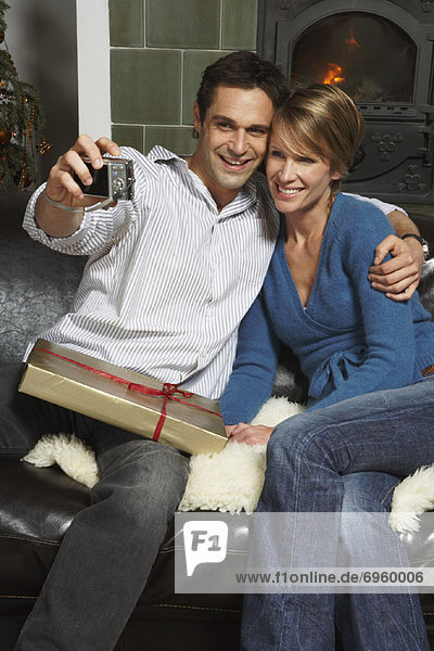 Couple Taking Photo of Themselves at Christmas