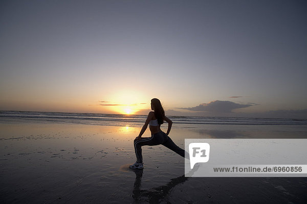 Woman Stretching on Beach at Sunset  Jacksonville Beach  Florida  USA