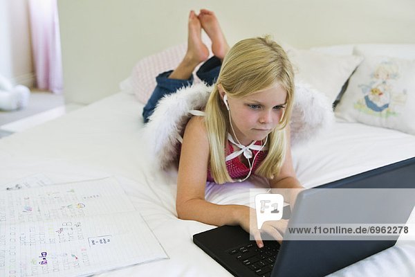 Girl Doing Homework on Laptop