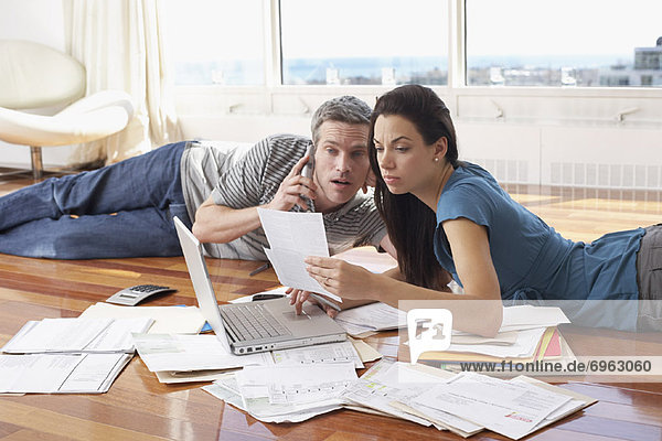 Couple with Bills and Laptop Computer
