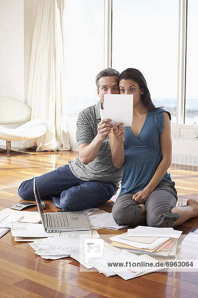 Couple with Bills and Laptop Computer