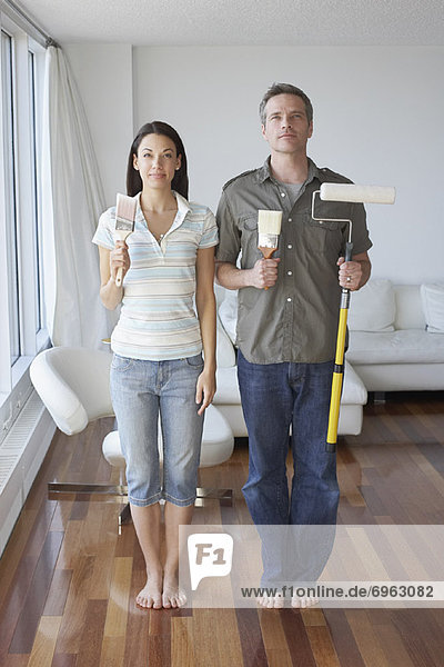 Couple in Apartment with Painting Supplies