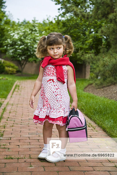Little Girl Carrying Lunch Bag