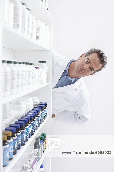 Pharmacist Looking at Pills on Shelf