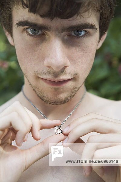 Portrait of Man Holding a Peace Sign Neckless