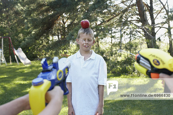 Kids Shooting Water Pistols at Apple on Boys Head  Elmvale  Ontario  Canada