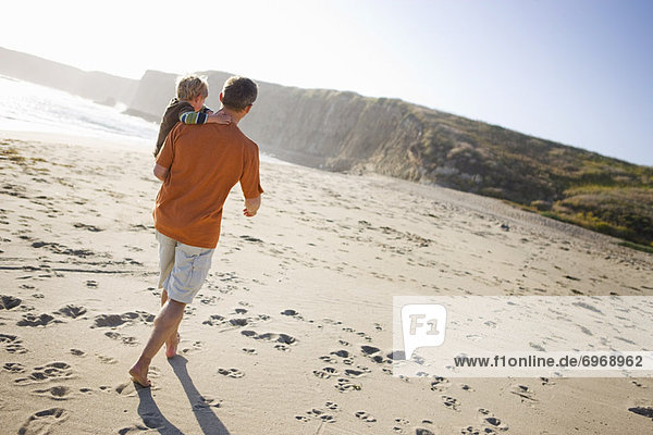Father and Son Walking on the Beach  Santa Cruz  California  USA